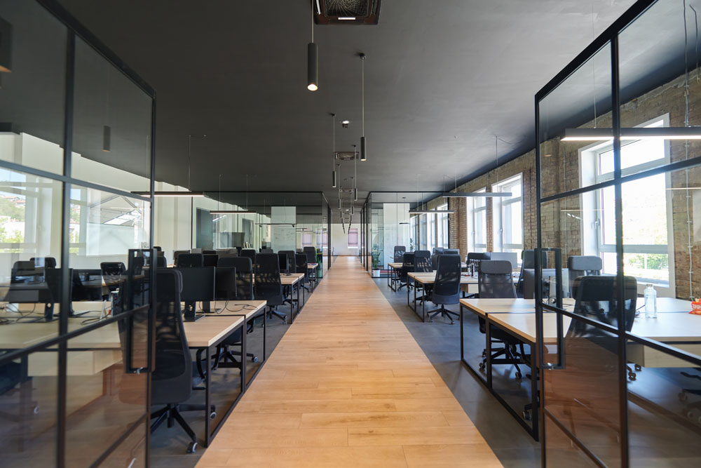 Clean modern office workspace with glass meeting rooms