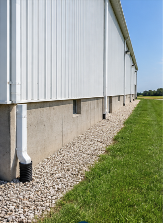 Clear gravel perimeter beside a metal agricultural building